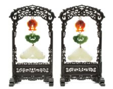 A pair of white jade chimes, 19th century  , each finely carved with figures amid a garden setting,