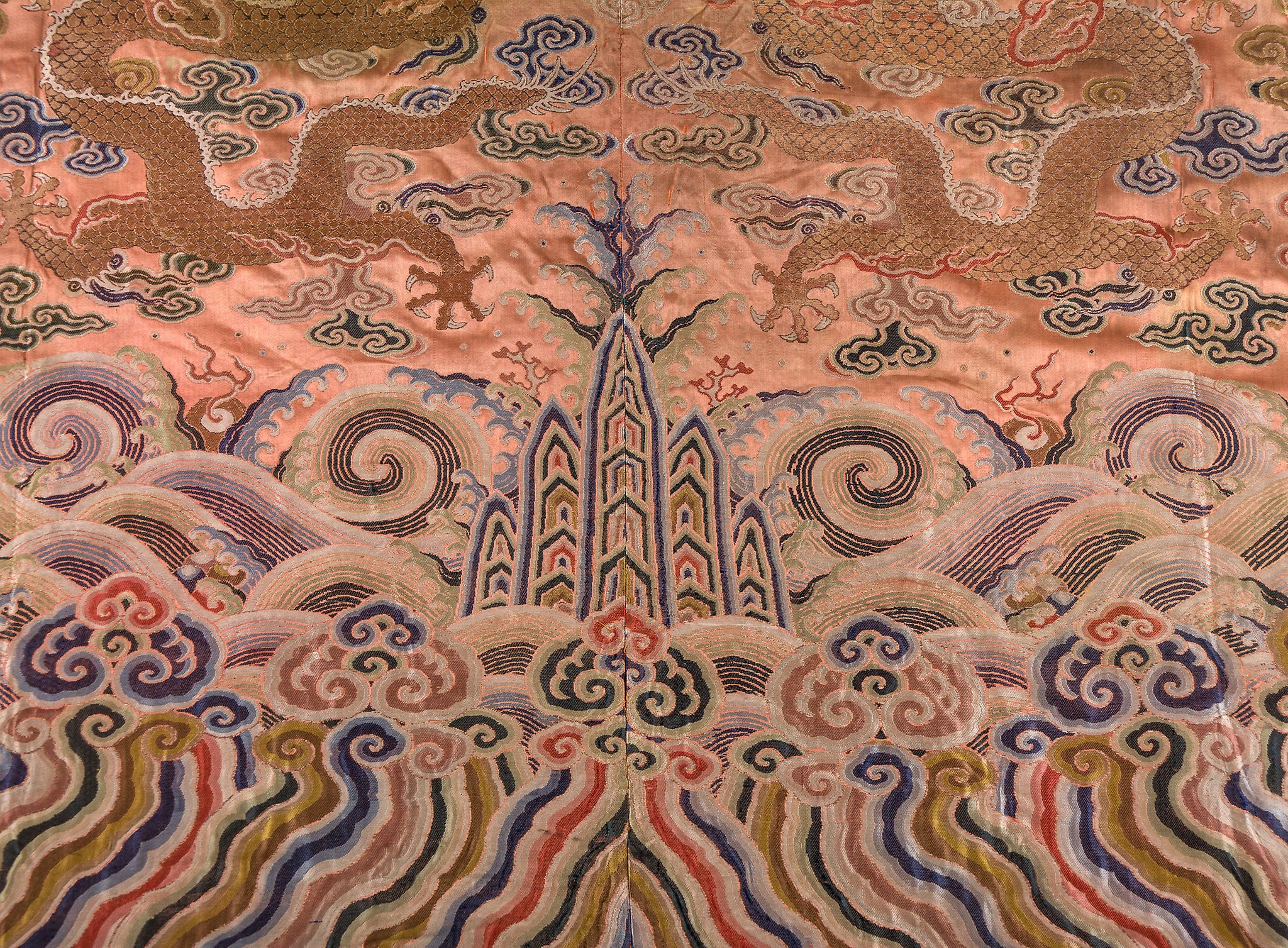 A coral ground silk Tibetan chuba, tailored from 18th century Chinese  kesi  , featuring eight - Image 7 of 8