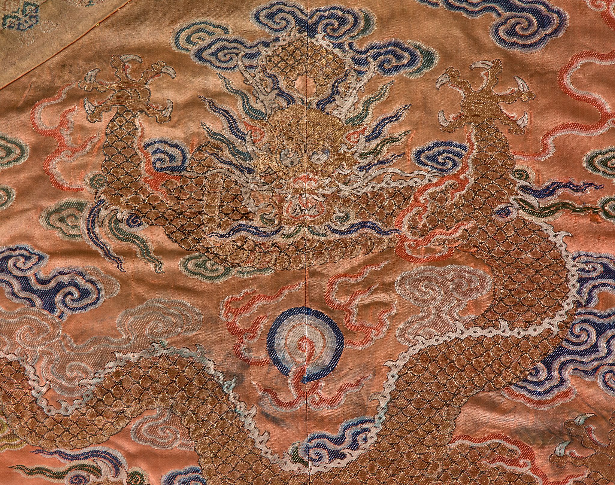 A coral ground silk Tibetan chuba, tailored from 18th century Chinese  kesi  , featuring eight - Image 6 of 8