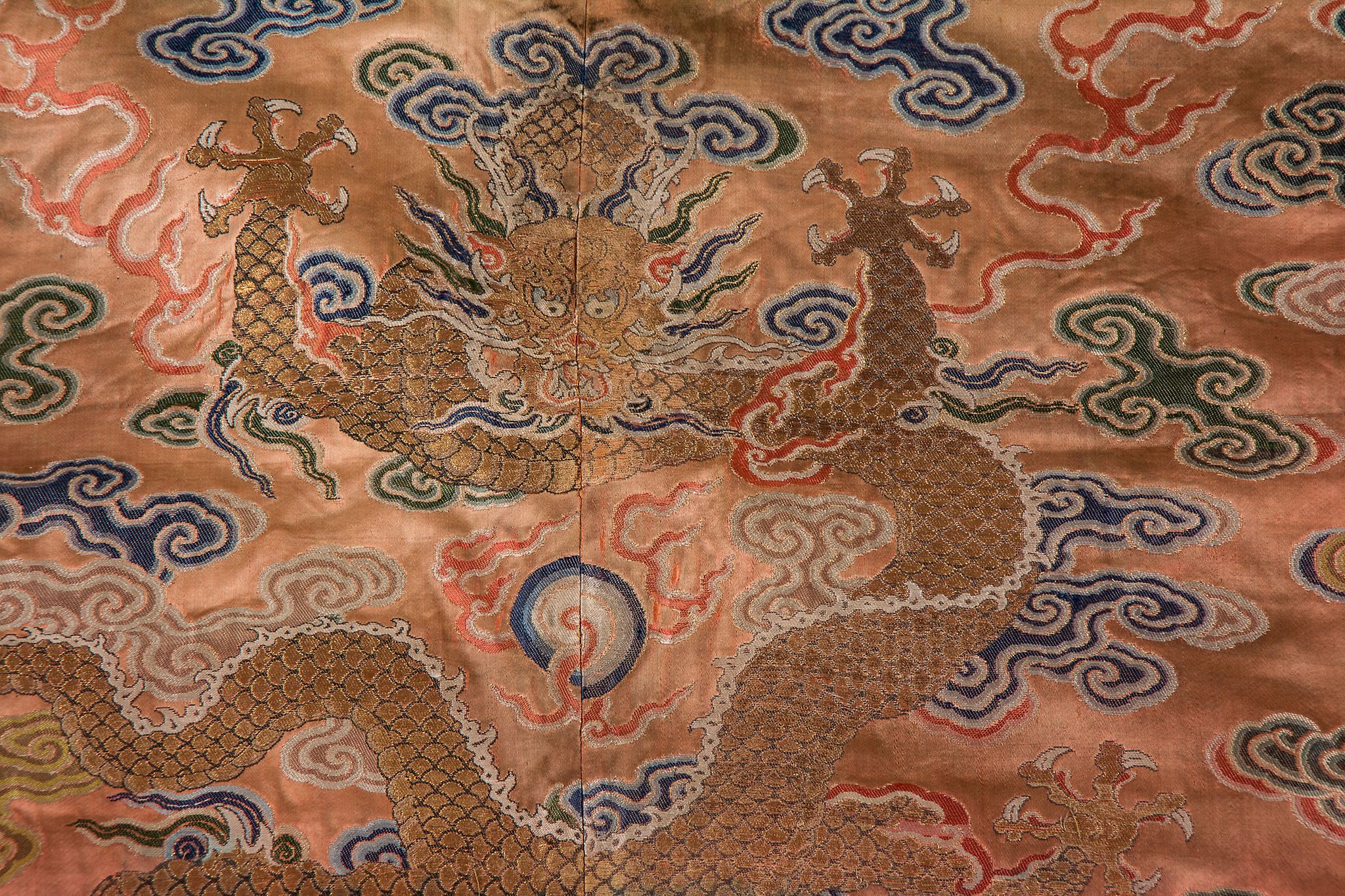 A coral ground silk Tibetan chuba, tailored from 18th century Chinese  kesi  , featuring eight - Image 8 of 8