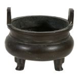A Chinese silver-inlaid bronze tripod two- handled censer,     ding  , decorated to the body with a