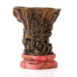 A wood libation cup, 19th century  , finely carved with sage figures and pavilions amid a