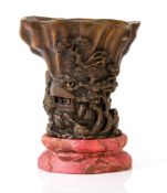 A wood libation cup, 19th century  , finely carved with sage figures and pavilions amid a