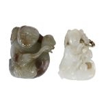 Two jade carvings of a boy and duck group  , the birds holding, respectively, a leafy stem and a