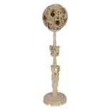 An ivory puzzle ball  , carved as at least six concentric balls within an outer case carved with