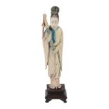 An ivory figure of a standing female figure, 19th century  , dressed in simple robes and holding a