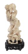 An Ivory Okimono of Shoki The Demon Queller,   the fearsome, bearded character stands holding aloft