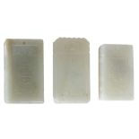 Three pale celadon jade plaques   of rectangular shape carved, respectively, with an immortal