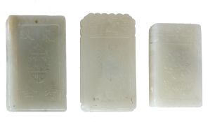 Three pale celadon jade plaques   of rectangular shape carved, respectively, with an immortal