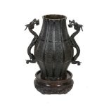 A Japanese Bronze Vase   of panelled bulbous form decorated with archaistic motifs on a key-fret