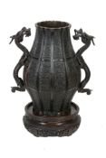 A Japanese Bronze Vase   of panelled bulbous form decorated with archaistic motifs on a key-fret