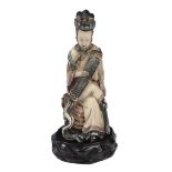An ivory snuff bottle, early 20th century  , carved in the form of a female figure seated on a