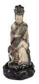 An ivory snuff bottle, early 20th century  , carved in the form of a female figure seated on a