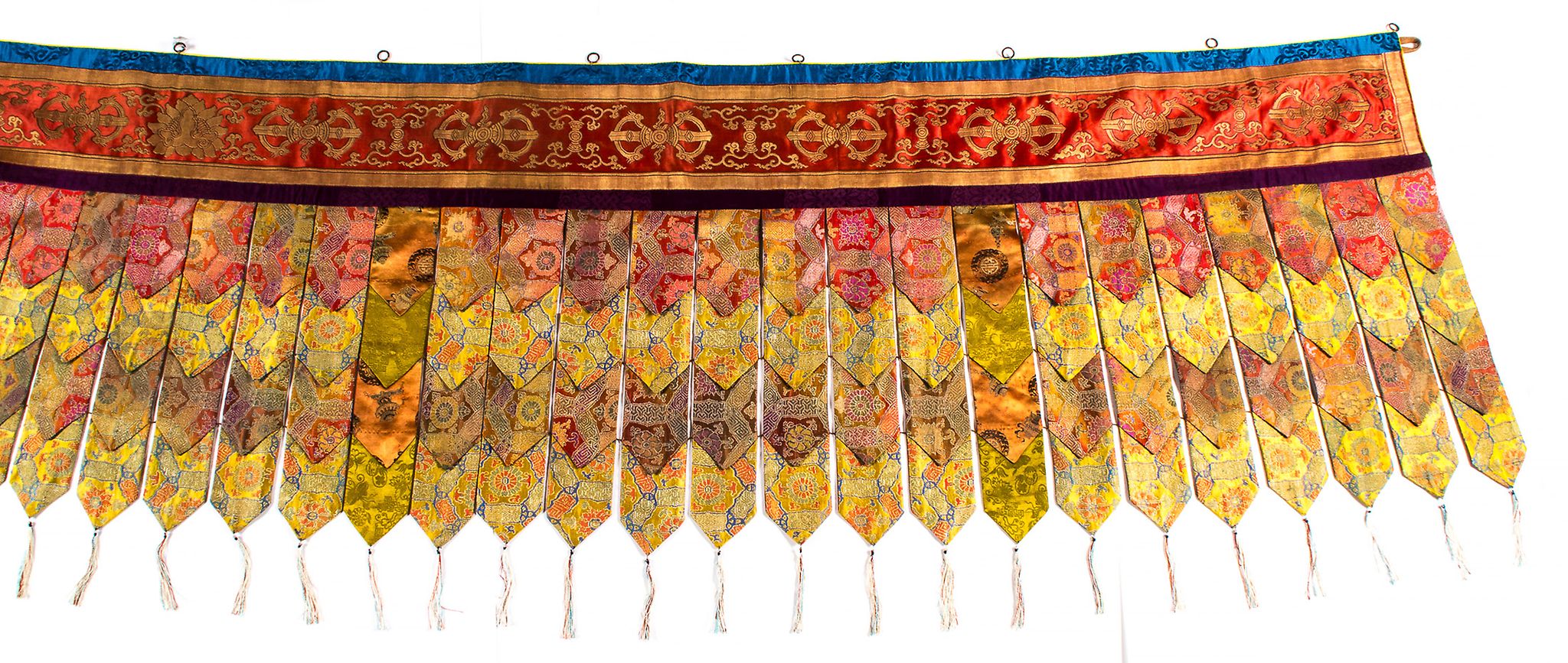 A Tibetan temple pelmet, 18th and 19th century  , consisting of a coral ground silk band - Image 2 of 2