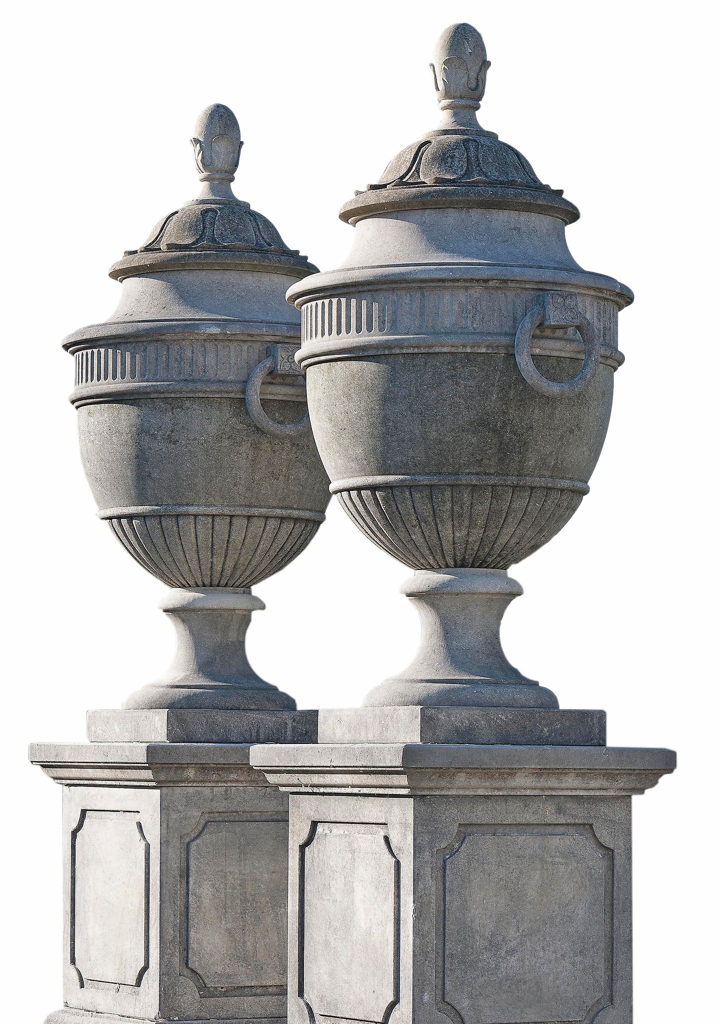 A pair of Continental carved limestone garden urns and covers, on pedestals  A pair of Continental