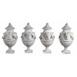 A set of four French sculpted white marble vases in Neoclassical style  A set of four French