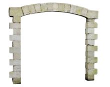 A Continental ashlar cut limestone arched gateway, 19th century, 326cm high  A Continental ashlar