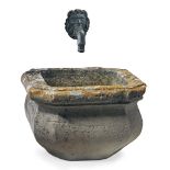 A French carved limestone basin with an associated bronze wall fount  A French carved limestone