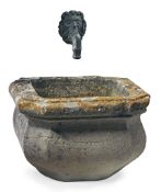 A French carved limestone basin with an associated bronze wall fount  A French carved limestone