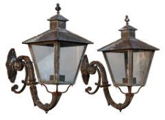 A pair of French copper, glazed and cast iron mounted wall lanterns  A pair of French copper, glazed