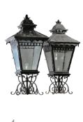 A pair of large wrought iron and glazed pier lanterns  A pair of large wrought iron and glazed