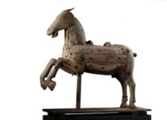 A Continental carved wood fairground horse, 19th century, the forelegs raised  A Continental
