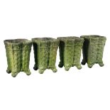 A set of four Continental stone composition planters in the form of baskets  A set of four