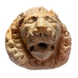 A sculpted marble wall fountain modelled as a lion's mask in Romanesque taste  A sculpted marble