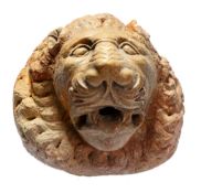 A sculpted marble wall fountain modelled as a lion's mask in Romanesque taste  A sculpted marble