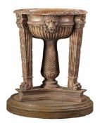 A sculpted rouge marble planter after a Roman marble basin and tripod  A sculpted rouge marble