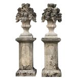 A pair of large Continental carved limestone models of fruit filled urns on...  A pair of large