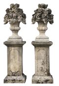 A pair of large Continental carved limestone models of fruit filled urns on...  A pair of large