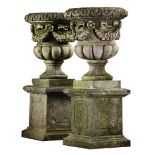 A pair of large Continental carved limestone garden urns with pedestals  A pair of large Continental