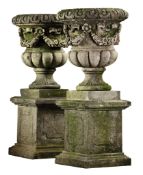 A pair of large Continental carved limestone garden urns with pedestals  A pair of large Continental