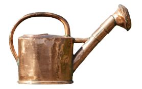 A polished copper watering can, late 18th century, of oval section  A polished copper watering can,