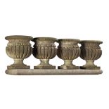 A set of four Continental carved limestone garden urns, 20th century  A set of four Continental