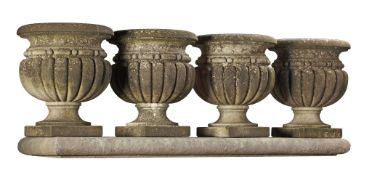 A set of four Continental carved limestone garden urns, 20th century  A set of four Continental