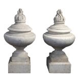 A pair of carved Carrara marble flambeau urn finials, 19th century  A pair of carved Carrara marble