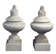 A pair of carved Carrara marble flambeau urn finials, 19th century  A pair of carved Carrara marble
