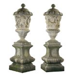 A pair of large Italian sculpted stone lidded urns after examples in the...  A pair of large Italian