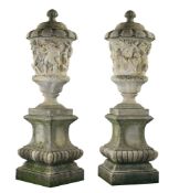 A pair of large Italian sculpted stone lidded urns after examples in the...  A pair of large Italian