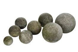 A set of eight graduated limestone spheres, 20th century  A set of eight graduated limestone