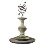 A wrought iron armillary sphere mounted onto a carved limestone pedestal  A wrought iron armillary