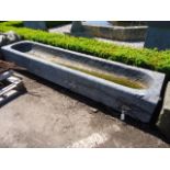 A rough hewn grey Bourgogne stone trough, 18th century, of rectangular section A rough hewn grey