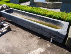 A rough hewn grey Bourgogne stone trough, 18th century, of rectangular section A rough hewn grey