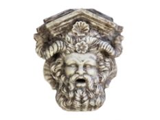 A carved marble wall fountain modelled as a Bacchic mask, 20th century  A carved marble wall