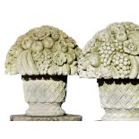 A pair of large Continental carved limestone baskets of flowers and fruit in...  A pair of large