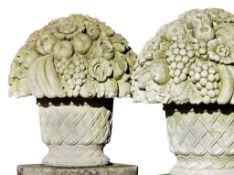 A pair of large Continental carved limestone baskets of flowers and fruit in...  A pair of large