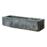 A Continental rough hewn limestone trough, 18th/ 19th century, 46cm high  A Continental rough hewn