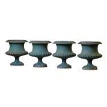 A set of four Continental green painted cast iron garden urns  A set of four Continental green